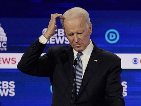 joe biden on the debate stage scratching his head in uncertainty