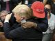 kanye west in a red maga hat hugging donald trump