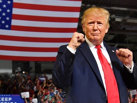 new poll shows trump leading in crucial 2020 swing states trump standing in front of american flag with his fists up in a boxing pose