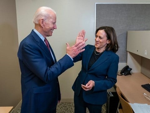 joe biden and vp selection kamala harris high fiving in a break room