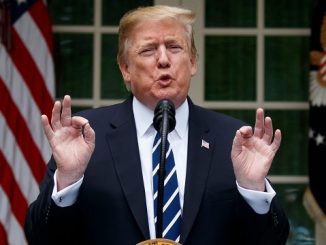 president donald trump at the podium giving the a ok sign with both hands