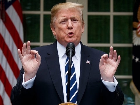 president donald trump at the podium giving the a ok sign with both hands