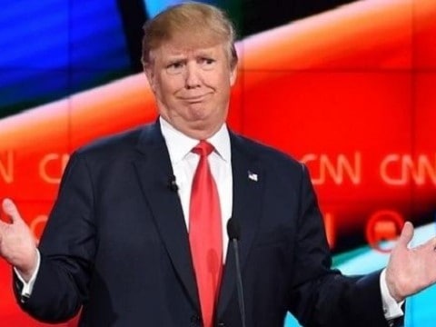 donald trump smirking and shrugging on stage