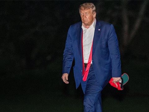 Donald Trump in blue suite walking away