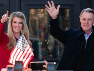 kelly loeffler and david perdue waving to crowd at political rally in georgia