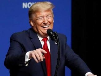 donald trump laughing and pointing at the podium